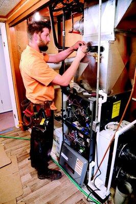 Technician Installing new Evaporator Coil for Air Conditioner.