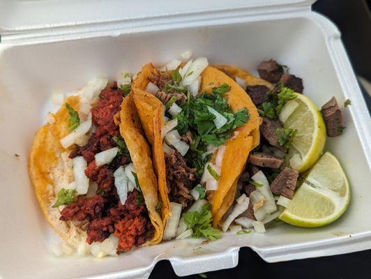 Chorizo, birria, lingua tacos with cilantro and onion.