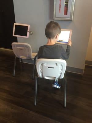 iPads for the kiddos makes waiting easy