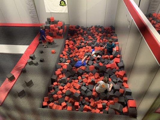 My kid and a bunch more lounging in a foam pit.