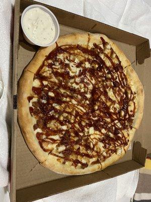 BBQ chicken pizza with bacon added and a side of ranch