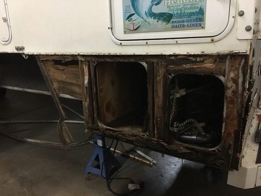 Dry rot at its finest on a lower rear section of a cab over camper.