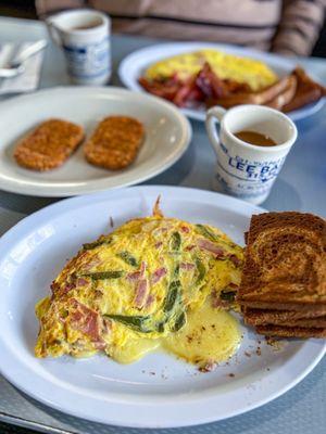 Western omelette with mozzarella cheese. Rye toast and hash brown patties on the side.