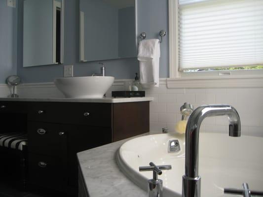 Classic clean lines for this master bathroom. Dark cherry cabinets, white and chrome fixtures add class and contrast.