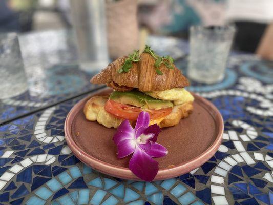 Breakfast sandwich- egg, bacon, cheese, avocado, tomato on croissant