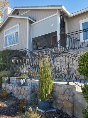 Metal railing with belly pickets, powder coated.