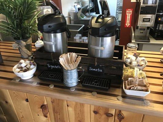 Self serve coffee bar when you order a house coffee. Creamers, honey, raw sugar, and Splenda.