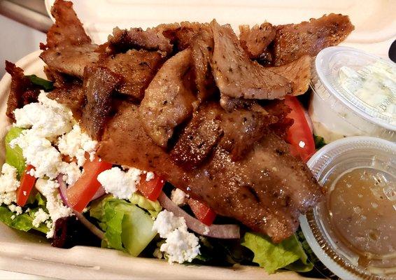 Lamb Salad .  Shaved lamb with romaine lettuce  red onion, roma tomatoes, feta, kalamata olives and oregano vinaigrette