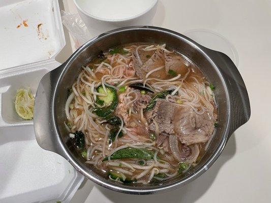 Unpacked takeout after adding broth #42 pho rice noodle soup with steak, flank and brisket.