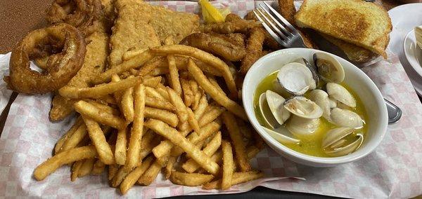 Captains plate with four pieces of fish, clams, calamari, oysters, prawns, fries, onion rings, and toast.