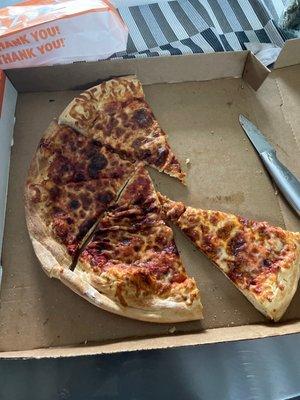 Burnt pizza that my kid had to cut himself since no one works there that knows how to run a business...