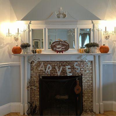 Inside the CENTURY 21 Advantage office building- a fireplace mantel is decorated for fall.