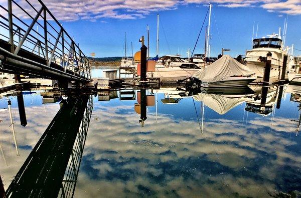 reflecting white clouds and boats