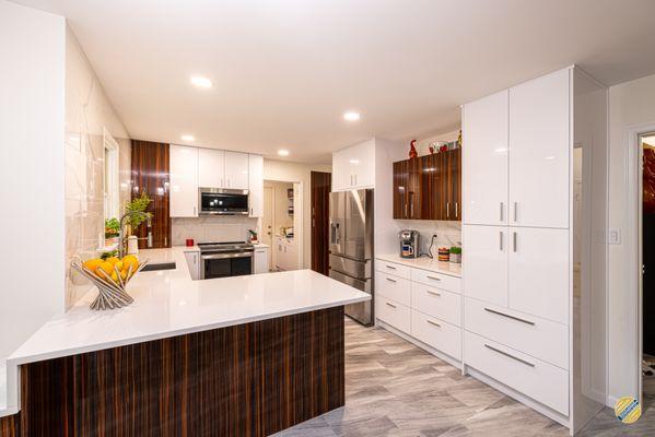 This stunning kitchen renovation intertwines the popular, modern white-and-chrome look with pops of creative elements.