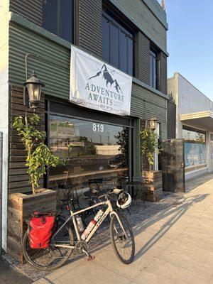 Paloma in front of Adventure Awaits Coffee Shop