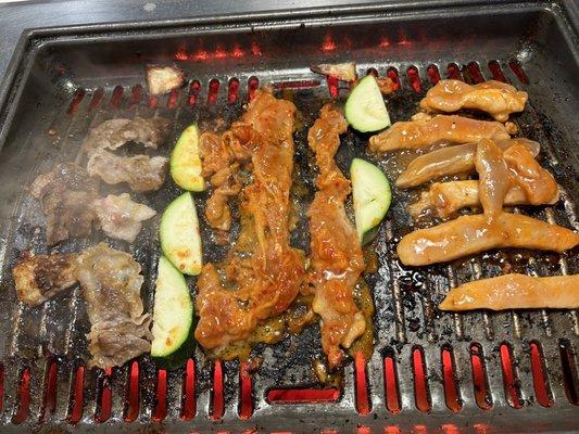 Meat, chicken and zucchini on the grill