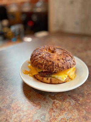 Silos Breakfast Sandwich on an Asiago bagel, with sausage, cheddar cheese and egg.