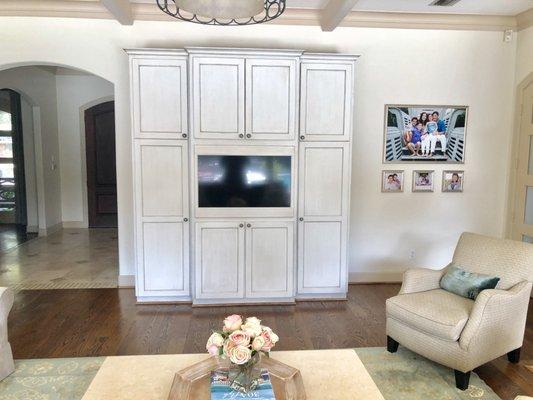 Custom cabinet work to have tv blend in with cabinet and automation to control anywhere in the home.