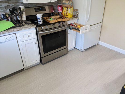 The flooring was laid below the kitchen appliances as well.