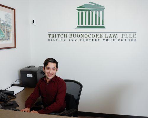 Our welcoming paralegal, Julio at the desk.