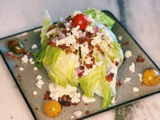 Unclassic Wedge with baby iceberg, bacon, blistered tomato, red onion, Pt. Reyes blue cheese dressing at Pacific Standard Prime steakhouse