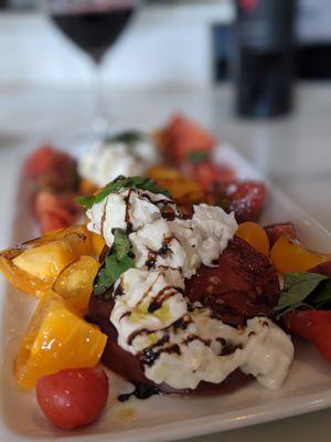 burrata caprese. heirloom tomatoes. basil. balsamic reduction. evoo. grey salt