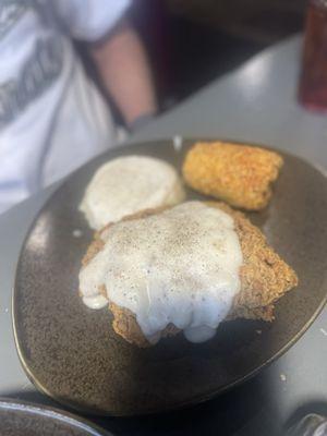 Country fried steak, mashed potatoes and fried corn on the cob