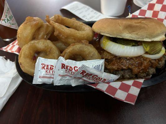 Chili cheese burger with onion rings.