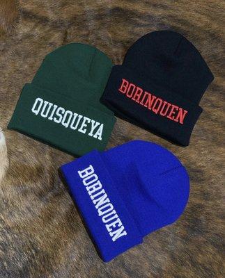 Detailed embroidery on beanies and other garments.