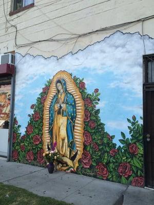 Image of The Virgin Mary painted on the side wall facing Worcester street.