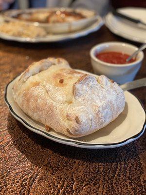 Smothered Calzone with sausage and roma tomatoes