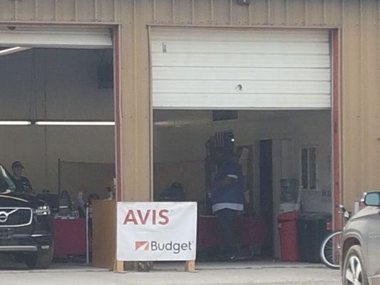 On the right side of this working garage is the Avis rental desk. Shocked to see how low Avis has fallen!