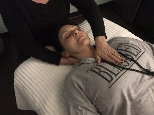 Lynn practicing Reiki (energy healing).