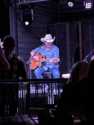 Mark Chesnutt playing on guitar, center stage.