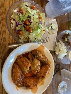 Buffalo chicken wings and a side salad.