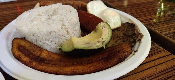 Bandeja Paisa - A combination plate of pork skin, steak, sausage, egg, rice, sweet plantain and avocado. Delicious and very filling!