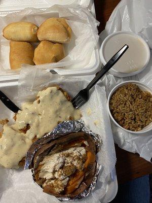 Smothered country fried chicken, sweet potato, seasoned rice, and rolls.  So good!