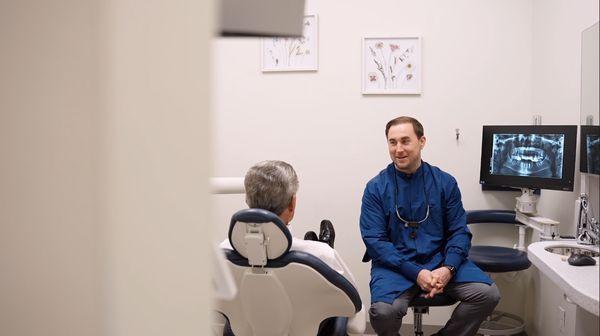 Dr. Joshua John with a patient talking about treatment options