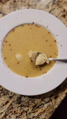 Bowl of Campbell's Chicken Wonton Soup with added red pepper flakes, black pepper and lite soy.