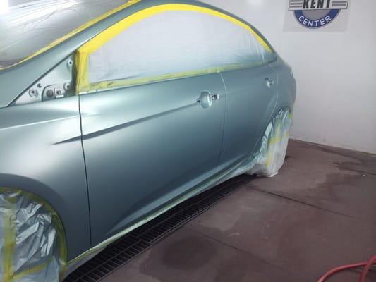 Car in the booth during the painting process. This is what the color base coat looks like before the clear is applied.