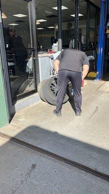 Staff taking the damaged tire for inspection