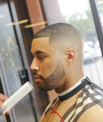 Fade, done by a barber. High bald fade with enhancements.