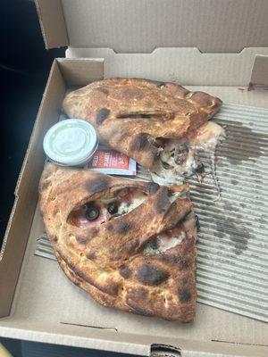 Calzone with ham pineapple and black olives.