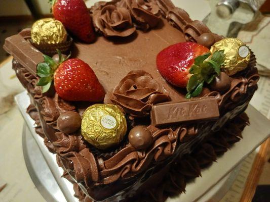 Chocolate drizzle cake with strawberrys and candy accessories