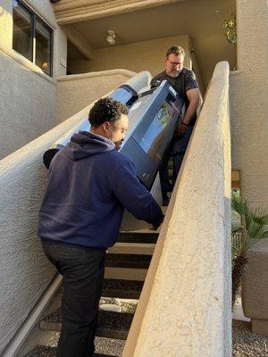 The crew from Little Moves moving a 218 pound printer down a flight of stairs. Very challenging!