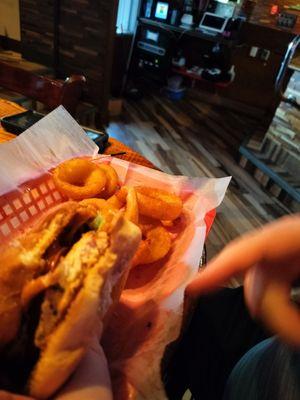 Texas Cajun Grilled chicken sandwich with onion rings.