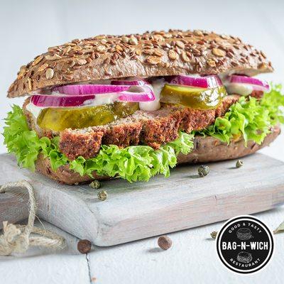 A delicious sandwich made with roasted pork neck, cucumber, and onion.