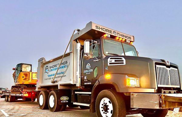 Shore Things Environmental truck with excavator-blue sky in background