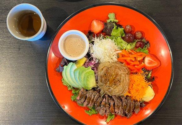 Steak, salad and noodles.