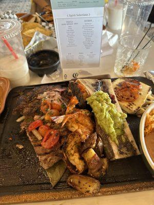 Steak with shrimp and potato and avocado with cheese and rice and beans